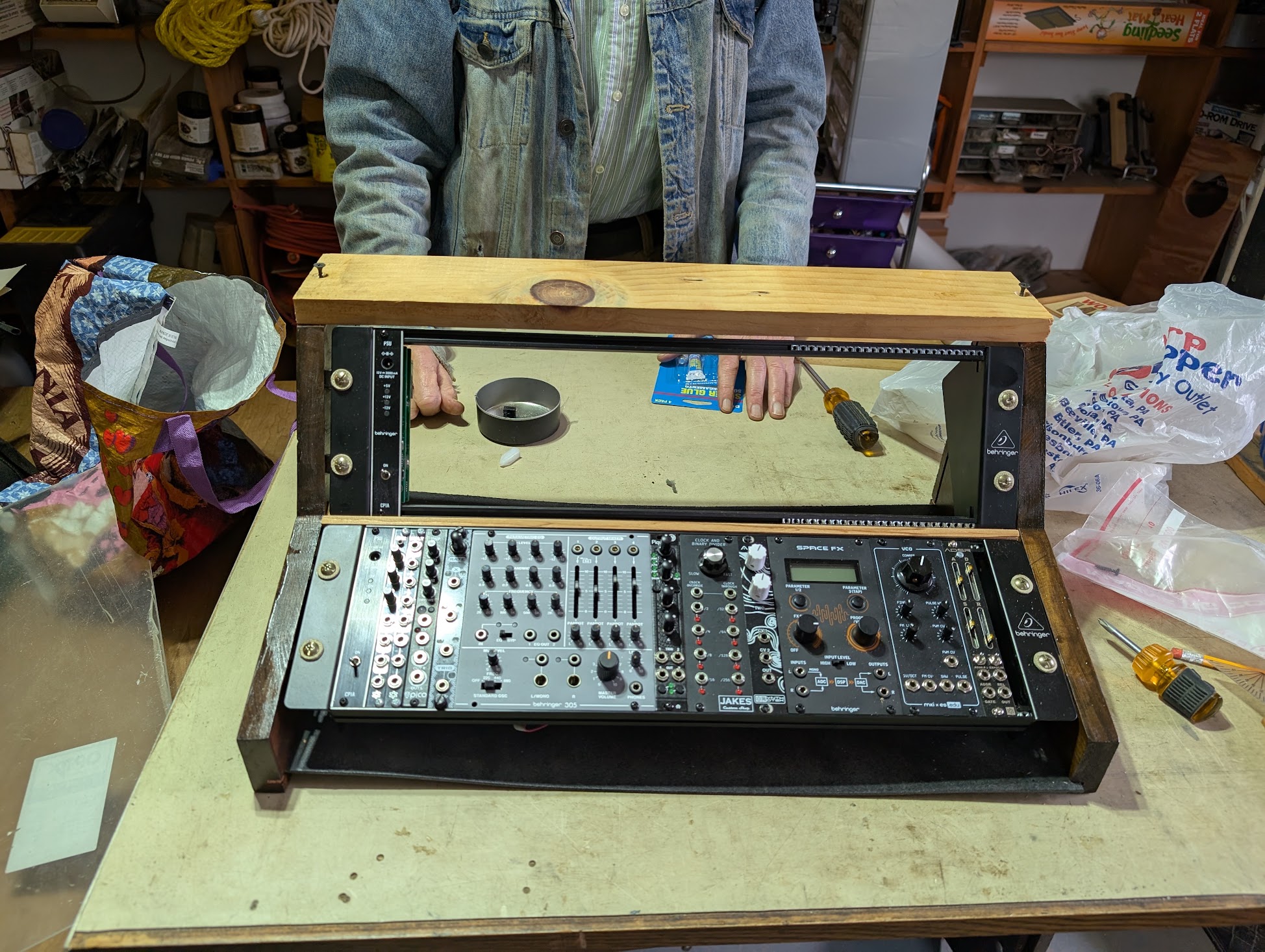 In progress photo of the modular rack build, showing the wooden housing for the metal racks.