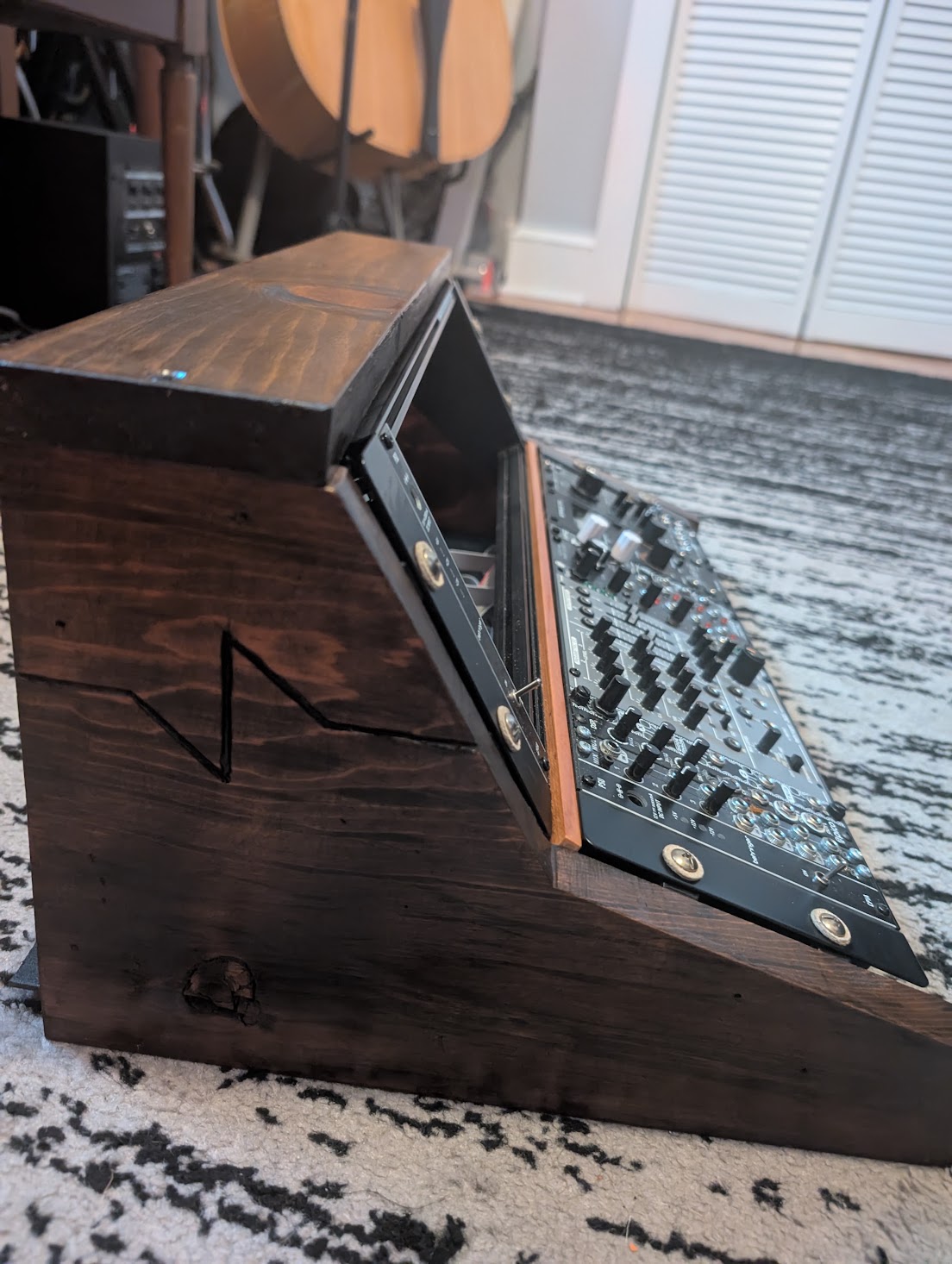 The other side of the modular rack housing, showing the emblem and the finished wood.